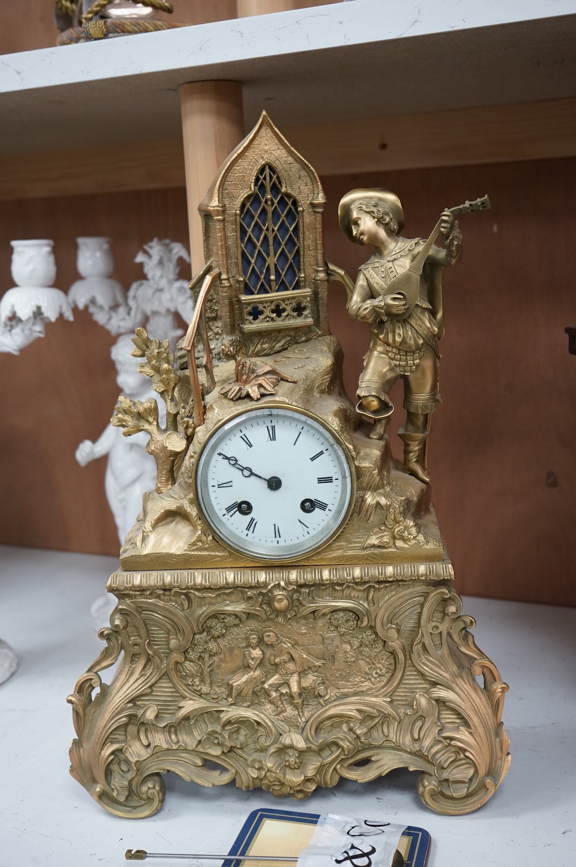 A late 19th century French gilt bronze mantel clock, with figural surmount, 42.5cm high.